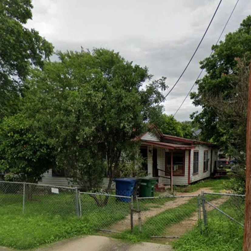 Older single-story house with an overgrown yard, before renovation