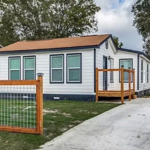 Renovated white house with new siding, windows, porch and cedar fence