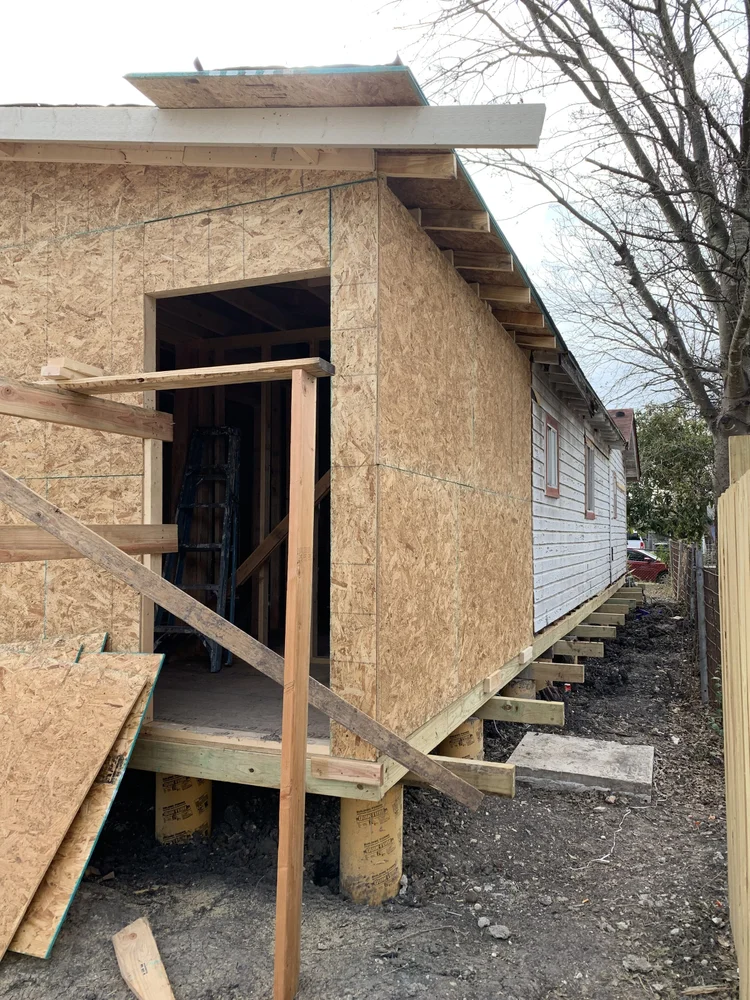 New exterior wall framing and sheathing on a house